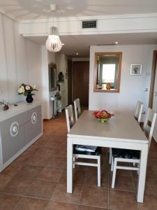 a kitchen and dining room with a white table and chairs at Lomas del mar V in Vera