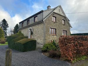 a brick house with hedges in front of it at Villa De Miguel in Paliseul