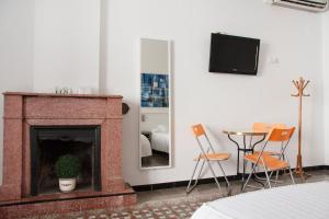 a room with a fireplace and a table and chairs at Hostal La Florida in Llança