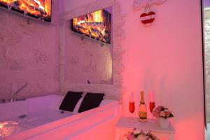 a bath tub with pink lighting in a bathroom at Casa Deky in Martina Franca +48 photos