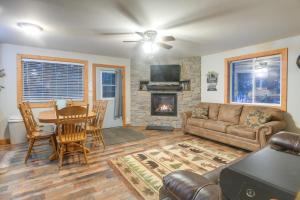 a living room with a couch table and a fireplace at Family Cabin with Fire Pit - 25 Miles to Yellowstone in Island Park