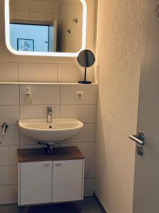 a bathroom with a sink and a mirror at Haus am Wasserturm Gästezimmer in Schorndorf-Schlichten in Schorndorf +63 photos