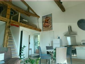 a kitchen and living room with a table and chairs at La Templerie in Châteauthébaud