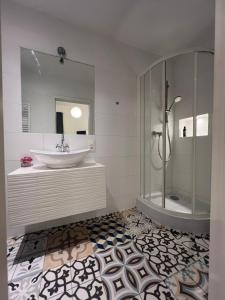 a bathroom with a sink and a shower at Fox hostel in Krakow