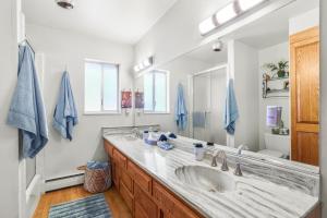 a bathroom with a sink and a large mirror at Tallac View in Stateline +40 photos