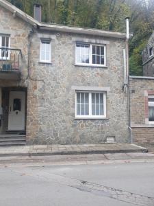 a stone house with a door and two windows at Douce Mathilde in Aywaille