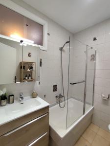 a bathroom with a shower and a sink and a tub at Camiño dos faros Malpica in Malpica
