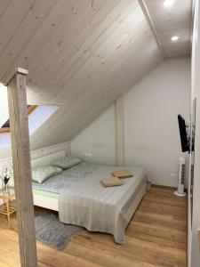 a bedroom with a bed in a attic at Villa Midesta in Šiauliai