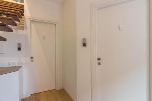 a hallway with two white doors and a staircase at P&M Belvedere Rooms in Olbia +66 photos