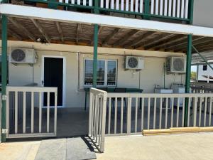 a building with a porch with two air conditioners at Comfortable studio in Bowen 4805 in Bowen