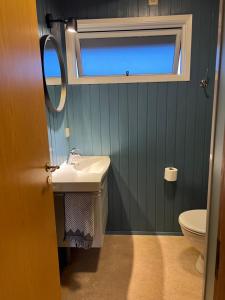 a bathroom with a sink and a toilet at Stay Happy Cottage - Golden Circle in Úthlid +17 photos