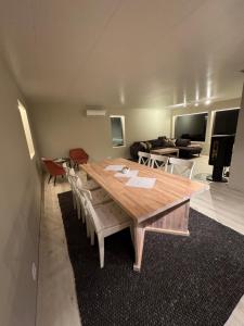 a living room with a wooden table and a couch at Flott enebolig nær naturen in Lyngen