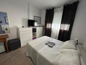 A bed or beds in a room at Faro de Cullera I