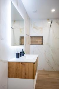 a bathroom with a sink and a mirror at Casa da Colina in Ferragudo +24 photos