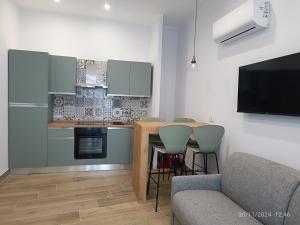 a kitchen with a table and chairs in a room at Villanova 48 in Naples