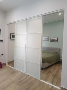 a large glass closet in a room with a bed at Villanova 48 in Naples +4 photos