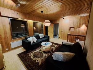 a living room with a couch and a table at House Lähde in Rovaniemi
