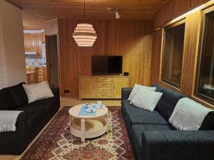 a living room with two couches and a coffee table at House Lähde in Rovaniemi