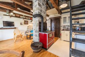 a kitchen with a red stove in a room at Guest House Vrelo in Virpazar