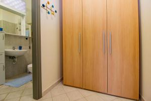 a bathroom with two wooden cabinets and a toilet at Casa Aurora in Sassari +30 photos