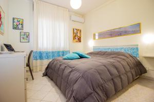 a bedroom with a bed with blue pillows on it at Casa Aurora in Sassari