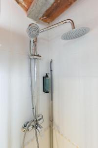 a shower in a bathroom with a shower head at Trinquet by Unik Vacation in Tarragona