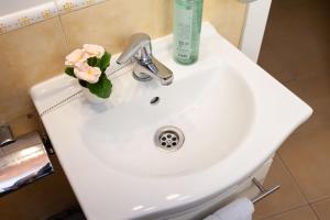 a white sink with a vase of flowers on it at Trinquet by Unik Vacation in Tarragona