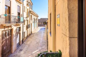 an empty alley between buildings in a city at Trinquet by Unik Vacation in Tarragona