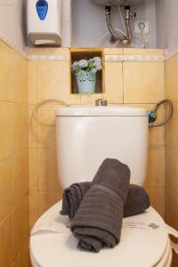 a bathroom with a toilet with a towel on it at Trinquet by Unik Vacation in Tarragona +36 photos