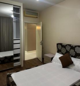 a small room with a bed and a closet at Apartment 6, Turquaz residence in Accra +15 photos