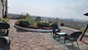 a group of chairs and tables on a patio at Apartment 6, Turquaz residence in Accra