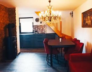 a dining room with a table and chairs and a chandelier at Dom IVET in Gdańsk +10 photos