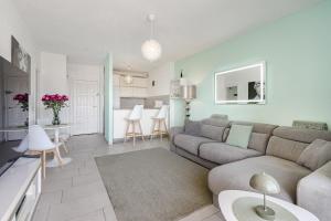 a living room with a couch and a kitchen at 14th floor Sea View in Adeje