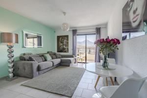 a living room with a couch and a table at 14th floor Sea View in Adeje