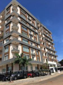a large apartment building with a fence in front of it at Apartment 6, Turquaz residence in Accra