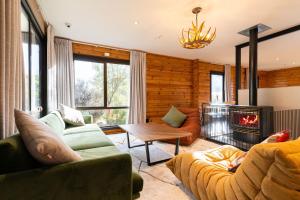 a living room with a couch and a fireplace at Haka House Hostel Aoraki Mt Cook in Mount Cook Village