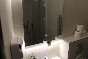 a bathroom with a shower with a mirror and a toilet at studio apartman Najdanović in Vrnjačka Banja +58 photos