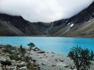 a blue lake in the middle of a mountain at Flott enebolig nær naturen in Lyngen +6 photos