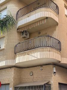 a building with a spiral staircase on the side of it at Apartamentos La Laguna II in Los Alcázares
