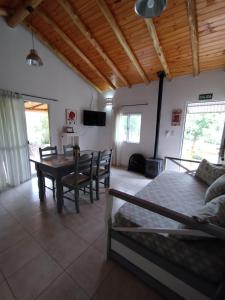 a living room with a bed and a table at Cabañas Paraje Noviembre in Nono