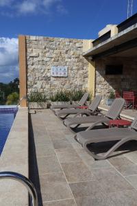 a row of lounge chairs next to a pool at Blue Veleta in Tulum