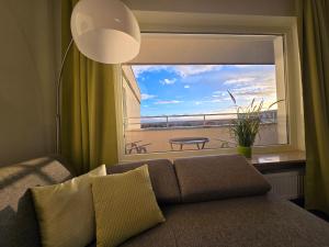 a living room with a couch and a large window at 1 Zimmer Wohnung Laatzen nähe Messe in Hannover