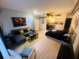 a living room with a black couch and a table at El Refugio de Abril in Alcalá de Henares