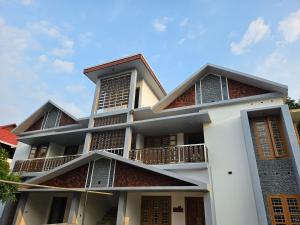 a building with balconies on the side of it at MetroNova Homes - Furnished stay in Ambalappuzha in Alleppey