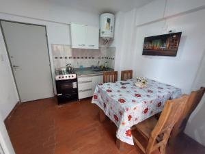 a small kitchen with a table and a stove at Sol y Luna Hospedajes 2 in San Bernardo
