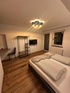 a bedroom with a bed and a chair in it at DAS MANFRED in Sankt Michael im Lungau