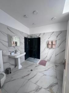 a white bathroom with a shower and a sink at Experiencebruges in Bruges +67 photos