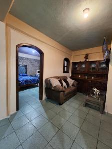 a living room with a couch and a mirror at Casa Gomez in Taxco de Alarcón
