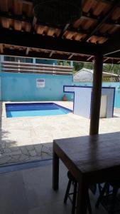a table in front of a swimming pool at Kandui Flats Maresias in Maresias