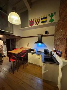 a kitchen with a wooden table and a kitchen with a dining room at La stanza dei citti-Lapo in Arezzo